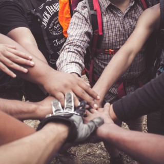 Young people joining hands
